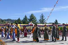 Students perform a Tibetan group dance, with “khata” ceremonial shawls.