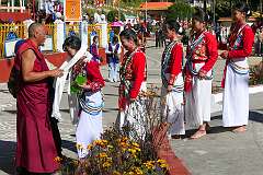 The dancers receive a khata” ceremonial shawls around their neck by a monk, as appreciation.