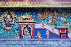 Buddhist paintings and bas-reliefs on the wall at the western side of the Thupsung Dhargye Ling Monastery.