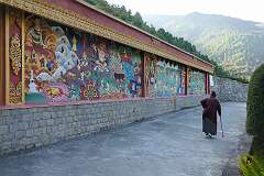 The wall on the west side of the Thupsung Dhargye Ling Monastery with colourful Buddhist paintings and bas-reliefs.