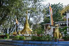 Gold-coloured “zedi” (stupa) and “chinthe”, a legendary lion-like creature, at the Vivek-Vihar, a Therevada Buddhist temple.
