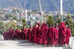 Novice monks reciting their prayers, overlooking the town.