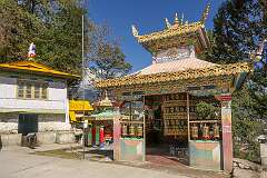 Prayer wheels a shrine at the western gate of Tawang Monastery.