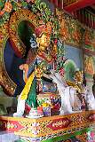 Statue of a bodhisattva with “thangka” ceremonial shawls, in the temple under the large Buddha statue.