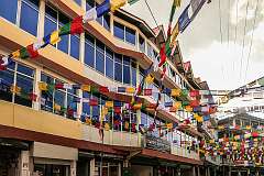 Hotel Tawang Centre Point with prayer flags over the streets, celebrating the Tawang Festival.