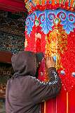Touching up a painting in the portal of the main prayer hall in Tawang Monastery.