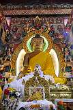 The 8-metre tall statue of the Shakyamuni Buddha in the main assembly hall of Tawang Monastery; in front is a throne, featuring a life-size cutout image of the 14th Dalai Lama.