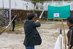 Aiming at the target, “Mlathan”, archery, a traditional game at the Tawang Festival.