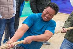 Playing “Thekpa-teng-ri”, tug-of-war, a traditional game played by men.
