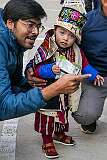 A man with a little girl in traditional Monpa dress at the Carnival Parade of the Festival of Tawang.