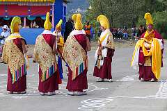 Monks with ceremonial headdresses, tea pot and Buddhist ritual Reed Shawn or Gya-Ling at the Drub-chod-Chen-Mo Cum Bomdila Torgya.