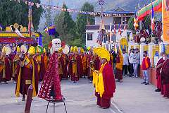Monks with ceremonial headdresses and the “Torma”, spiritual cake.