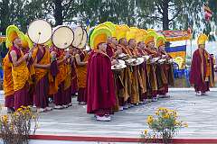 Monks with ceremonial headdresses playing pairs of Cymbals (“Bub”) and Ritual Drum (“Choe-Nga”) back at the dancing ground.