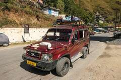 The Tata Sumo on the road, with the Samten Yeshi Choling Monastery.