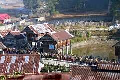 Women arriving with baskets of rice, for the Eli ceremony in Tajang.