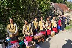 Women with drinks for the participants along the road.