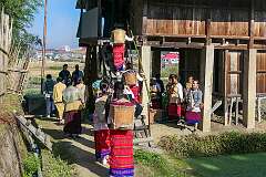 The bride and friends and relatives bringing baskets of rice to the rice barn of her in-laws, for the Eli wedding ceremony.