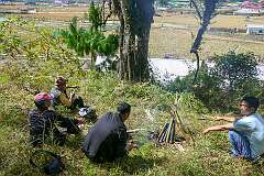 Sitting around the fire, while cooking eggs in bamboo tubes near Tajang Village.