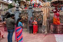 Having their photo taken in front of a shrine with bells on the Kamakhya temple grounds, most sacred and oldest of the 51 Shakti Peethas on earth,