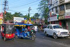 Autorickshaws and a Hindustan Ambassador along Lumding-Silchar Road at the junction with Itkhola Road in Silchar.