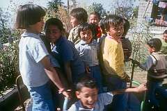 Children playing on a small merry-go-round, in the Tibetan Children's Village.