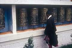 Devotee at the prayer wheels in the Dalai Lama's temple, the Tsuglagkhang.