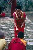 A young Buddhist novice monk practicing debating at the Tsuglagkhang, the Dalai Lama’s monastery