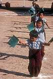 Little boys dancing with green flags as part of the festivities.