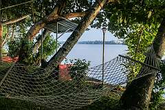 A hammock at Ashtamudi Villas in Mathilil, looking across Ashtamudi Lake to Kollam.
