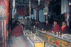 Monks starting a daily “puja” religious ceremony, with reciting sacred texts, sutras and mantras.