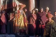 The abbot with the “damaru”, a small two-headed drum, and a monk reading Buddhist texts.