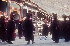 Senior monks dancing around food, part of the ceremony in the inner courtyard of the monastery.