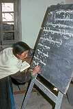 A teacher writing Bodhi (Tibetan) on the blackboard during a lesson in Leh Girls' High School.