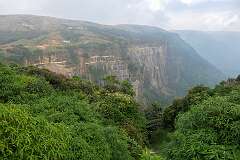 View towards the cliff with Arwah Cave, from the Sohra-Shella Road, 5 kilometres north of Cherrapunji (Sohra).