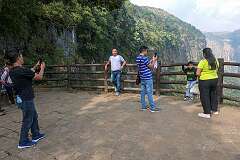Tourists photographing each other on the viewpoint to the falls.