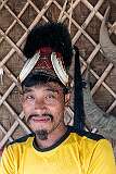 Tonyei Ahng, a young Konyak Naga man and second chief of Sheanghah Chingnyu, wearing traditional headgear at his house.