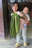 A young girl carrying her little brother from the church in Sheanghah Chingnyu.