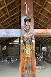 Wood carving of a Chang chief and the log drum with a carved leopard's head, in the Morung, traditional 'bachelors' dormitory' house of the Chang tribe in Kisama Heritage Village.