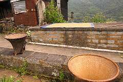 Woven baskets and drying rice near the monument above Khonoma village.