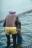 A Sikh man bathing his son in the sarovar (holy pool) at the Golden Temple in Amritsar, the holiest place of the Sikh religion.