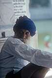 A Sikh man at the Golden Temple. Hair is allowed to grow naturally as a gift from God, tied in a knot and covered with a turban, one of the outward symbols ordered by Guru Gobind Singh in 1699 as a means to profess the Sikh faith.