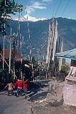 A street with Buddhist prayer flags, walking down to Gangtok city.