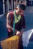A monk fastening a prayer flags in Rumtek Monastery, also called Dharma Chakra Centre.