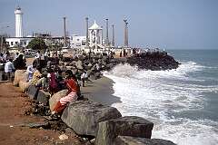 The shorefront with the lighthouse and a statue of Ghandi in Puducherry (Pondicherry, a former French colony).