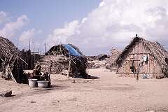 A mother bathing her daughter in front of palm leaf huts in Dhanushkodi, east of Rameswaram.