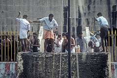 Bathing at one of the 22 Tīrtha (theertam, wells) where they are doused with water that are thought to have curative powers, in the Ramanathaswamy Temple in Rameswaram.