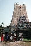 Devotees bathing with water from one of the 22 “theerthams”, sacred springs in Ramanathaswamy temple; a “gopuram”, towering entrance to the temple, is in the background.