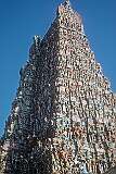 Detail of one of the brightly painted “gopuram” towers, covered with figures of divinities, celestial beings, monster masks, guardians, and animal mounts.