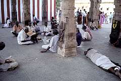 Men listening to  readings from sacred texts in one of the pillared halls of the  Meenakshi Temple.