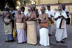 A group of Devotees reading from sacred texts in a courtyard of the Meenakshi Temple (also called Arulmigu Meenakshi Amman Thirukkovil), in Madurai.